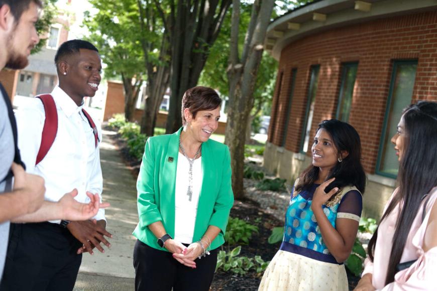 students outside with president